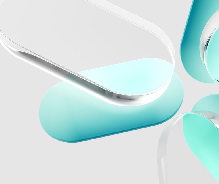 Close-up of four translucent, pill-shaped objects with rounded edges, arranged in a circular pattern with their ends pointing toward the center.