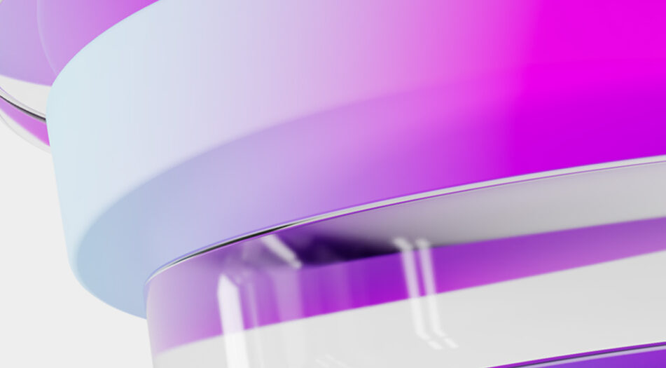 Close-up of a glossy curved surface with a gradient from light blue to pink and purple, set against a plain white background.