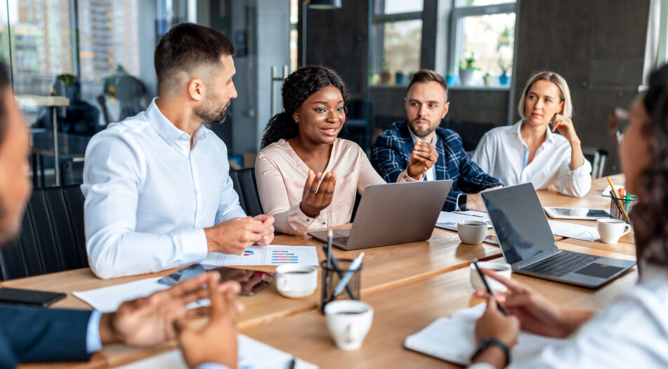 People sat around a table working together.